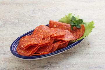 Sliced pepperoni sausage in the bowl