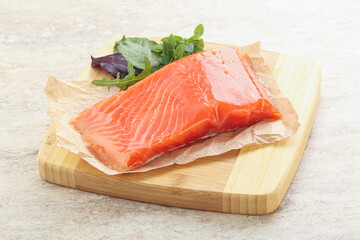 Raw salmon fillet over board