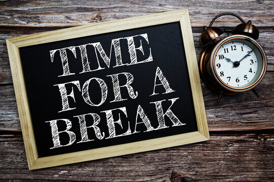 Time For a Break word with alarm clock on wooden background