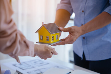 Close up of hands working and brainstorming on paperworks and floor plan drawings about design architectural and engineering for houses and buildings.