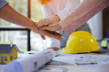 Close up of hands working and brainstorming on paperworks and floor plan drawings about design...
