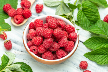 Raspberry in bowl on light background. Organic Raspberry. Red berry. top view with copy space