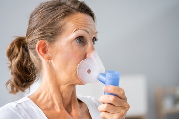 Woman with asthma inhaler - obrazy, fototapety, plakaty