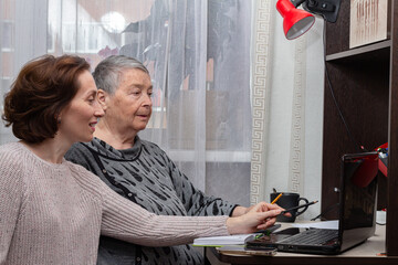Two female professional successful economists are watching condition currency on Exchange via...