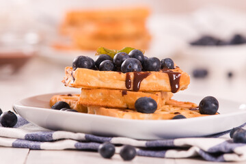 Waffles with blueberries and chocolate cream. 