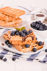 Waffles with blueberries and chocolate cream. 