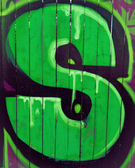 Graffiti letter S in slime green.