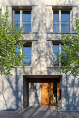 View to entrance door of a modern residential building with new apartments in the city - 515979467