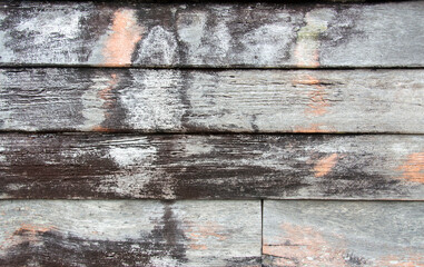 The walls of old planks are stacked next to each other.