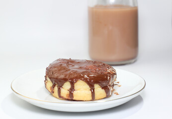 chocolate donut and a cup of chocolate milk
