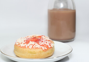 chocolate donut and a cup of chocolate milk