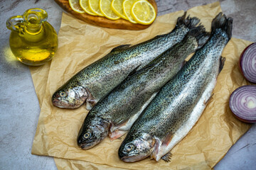 Three raw trout ready to be cooked.