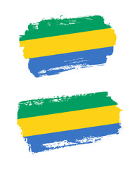 Obraz premium Set of two creative brush painted flags of Gabon country with solid background