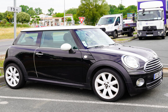 Mini Black Car Parked In Street With White Wheels