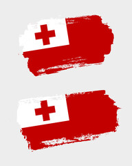 Set of two creative brush painted flags of Tonga country with solid background