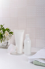 Natural cosmetics, skin care product on table in bathroom. Blank cosmetic skincare makeup containers.