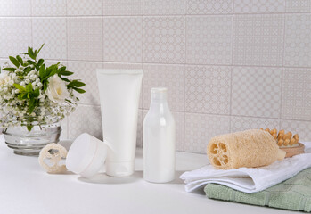 Fototapeta na wymiar Natural cosmetics, skin care product on table in bathroom. Blank cosmetic skincare makeup containers.