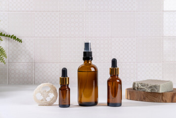 Various Facial Massage Oils. Natural cosmetics, skin care product in brown glass bottles on tablein bathroom. Spa cosmetics.