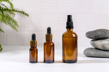Various Facial Massage Oils. Natural cosmetics, skin care product in brown glass bottles on tablein bathroom. Spa cosmetics.