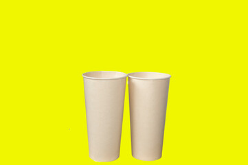 Two tall brown paper cups without lids.