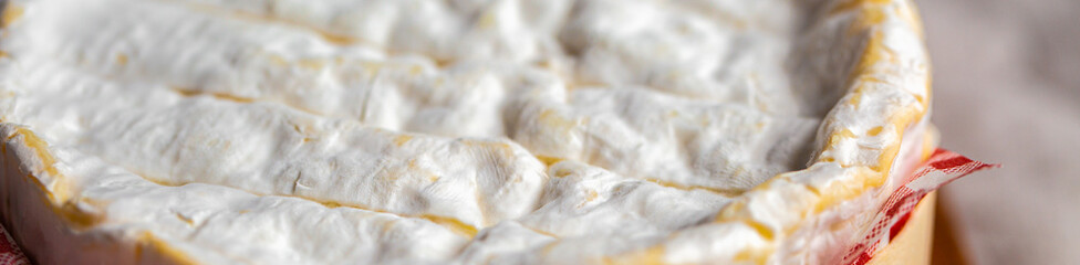 Sliced ​​piece of Camembert. Camembert close-up. Macro photography of cheese for the cover. Camembert advertisement. Cheese for the cover. Brie advertisement. Brie close-up. Cheese with mold close-up.