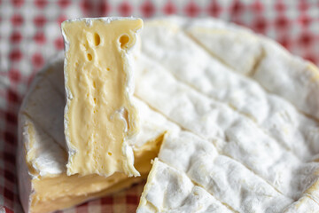 Sliced ​​piece of Camembert. Camembert close-up. Macro photography of cheese for the cover. Camembert advertisement. Cheese for the cover. Brie advertisement. Brie close-up. Cheese with mold close-up.