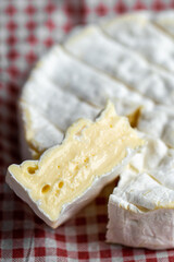 Sliced ​​piece of Camembert. Camembert close-up. Macro photography of cheese for the cover. Camembert advertisement. Cheese for the cover. Brie advertisement. Brie close-up. Cheese with mold close-up.