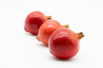 Group of pomegranate closeup isolated on white background.