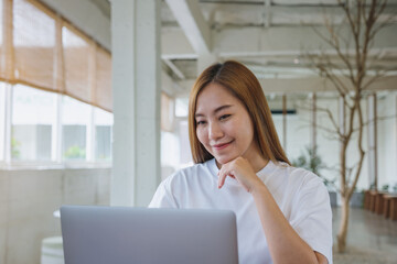 Portrait image of a businesswoman working on laptop computer