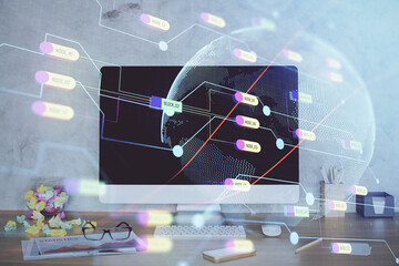 Double exposure of desktop with computer and world map hologram. International data network concept.