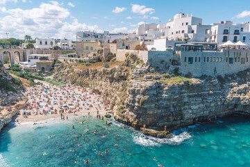 Beautiful aerial view of Polignano a Mare, Bari, Puglia, Italy, with white stone houses, cliff,...