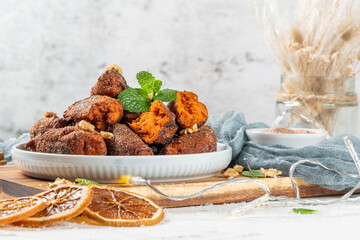 Traditional portuguese Christmas sweets named Bilharacos with sugar and cinnamon on kitchen countertop. This sweets are made with pumpkin. Is traditional in Aveiro region