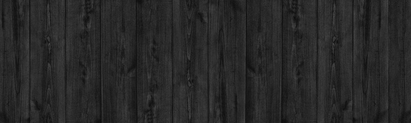 Black natural shabby fine textured wood board panoramic background. Rough old grainy wooden plank...