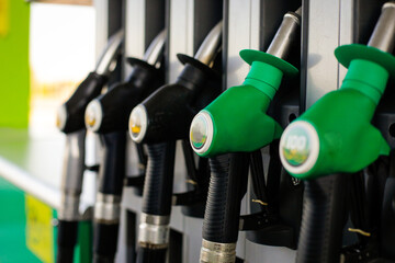 Shallow depth of field (selective focus) details with fuel pumps at a gas station.