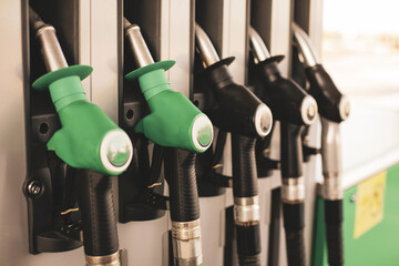 Shallow depth of field (selective focus) details with fuel pumps at a gas station. - obrazy, fototapety, plakaty