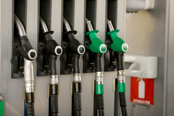 Shallow depth of field (selective focus) details with fuel pumps at a gas station. - obrazy, fototapety, plakaty