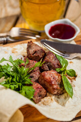 Pork kebab with a large glass of beer