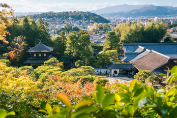 Panoramic view at the golden hour from the hilltop of the Silver Pavillion or Ginkaku-Ji Zen Temple and gardens, and the city of Kyoto in the background in Kyoto, Japan.