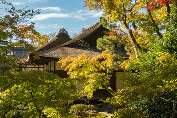 Beautiful autumn colours and a traditional Japanese garden in golden light at the Silver Pavillion or Ginkaku-Ji Zen Temple and gardens, one of the 'must-see destinations in Kyoto, Japan.