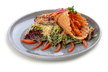 Salad with sweet and sour chicken in a waffle cone on a bed of lettuce leaves. On a white background, isolated.