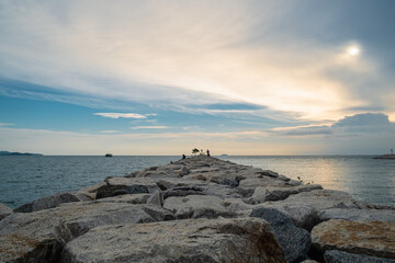 Breakwater on the beach at sunset time.