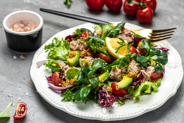 Close up tuna salad with lettuce, cherry tomatoes, avocado and red onions. superfood concept. Healthy, clean eating concept. Vegan or gluten free diet. Top view