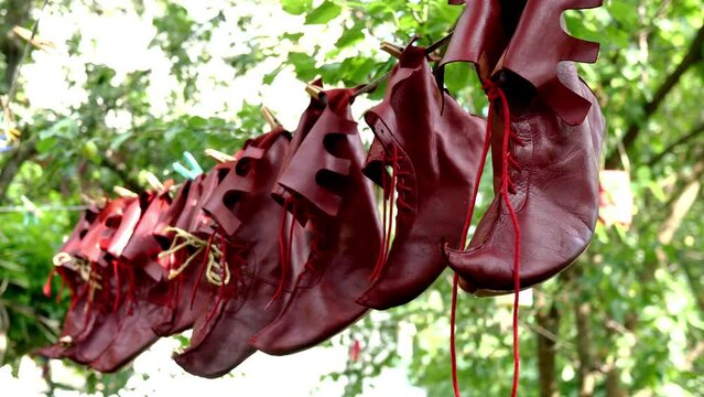 Special theatrical leather jester shoes are dried or ventilate after cleaning in backyard. Close-up. Outdoors.