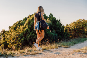 Attractive sporty woman in shorts gone outdoor with warm evening light