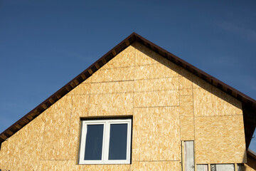 Roof of house. Roof on country house. Windows in wall.