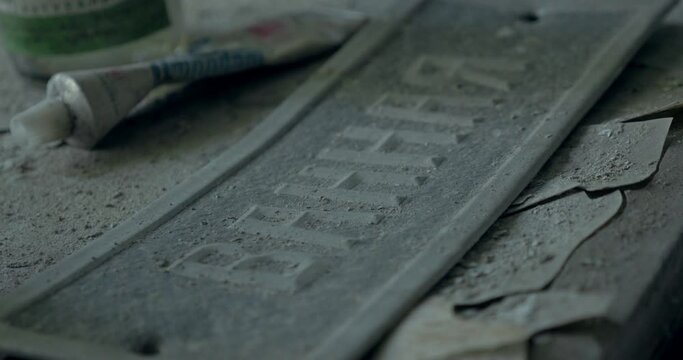 Old ruined soviet sign on the ground close-up