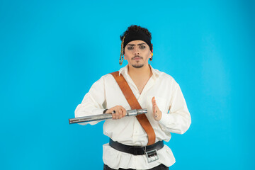 Confident pirate closing his binocular and looking at camera