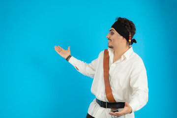 Young pirate looking aside and opened his arms wide