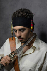 Close-up portrait of handsome pirate put knife to his throat