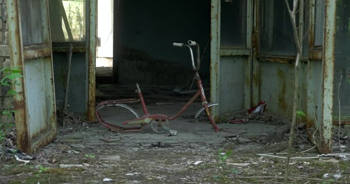 Old broken bicycle in front of ruined building